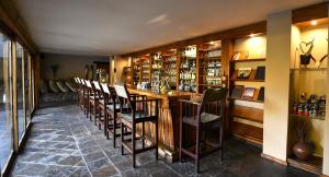 a room with a bar with a bunch of chairs at Sediba Luxury Safari Lodge in Welgevonden Game Reserve