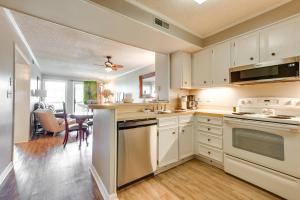 une cuisine avec des placards blancs et une salle à manger dans l'établissement Walk to Coast North Myrtle Beach Condo with Pool!, à Myrtle Beach
