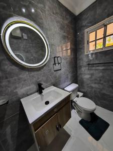 a bathroom with a sink and a toilet and a mirror at DulceVilla_en la playa in Boca Chica