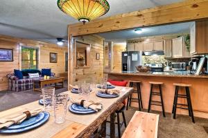 a kitchen and living room with a table in a cabin at The Eagle's Nest Mountain Cabin Gatlinburg in Gatlinburg