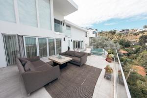 a patio with two chairs and a table on a balcony at Vista Bliss Retreat-Private Room in Los Angeles