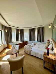 a hotel room with a large bed and a table at Newalla Hotel Old City in Istanbul
