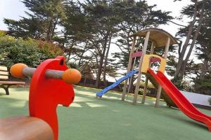 a playground with two slides and a slideintend at Appartement de Tamaris (4 pers) in Le Pouliguen