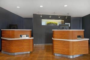 a lobby with two wooden counters and a counter top at Courtyard Chicago Elmhurst/Oakbrook Area in Elmhurst