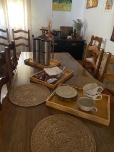 a wooden table with plates and bowls on top of it at Casa Piedralén in Cervera del Río Alhama