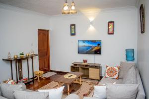 a living room with a couch and a table at Classy African - themed 1 BR apartment in Karen in Karen