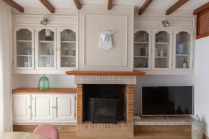 TV a/nebo společenská místnost v ubytování Casa con jardín junto a la playa