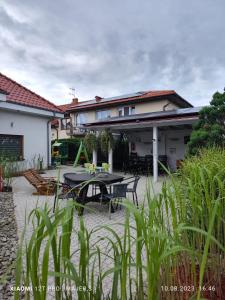 a patio with a table in front of a house at Villa Zosia in Rowy