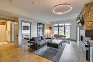 a living room with a couch and a fireplace at Modern Winter Park Condo with Community Hot Tub! in Winter Park