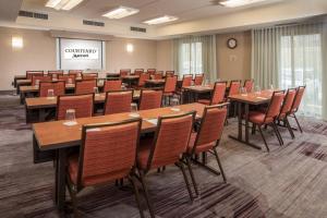a conference room with wooden tables and chairs at Courtyard By Marriott Baltimore BWI Airport in Linthicum Heights