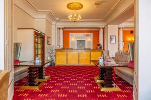 a large room with a red carpet in front of a stage at Muthu Alexandra Hotel in Oban