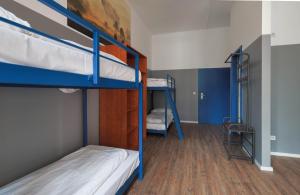 Schlafsaal mit 2 Etagenbetten und einer Leiter in der Unterkunft Pegasus Hostel Berlin in Berlin