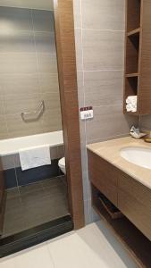 a bathroom with a sink and a toilet and a shower at La View Homestay in Manzhou