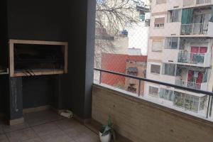 a balcony with a window with a view of a building at Impecable departamento en Caballito. in Buenos Aires