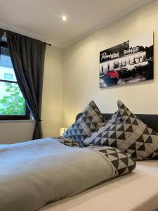 a bedroom with a bed with two pillows on it at Moderne Ferienwohnungen in Dissen in Dissen