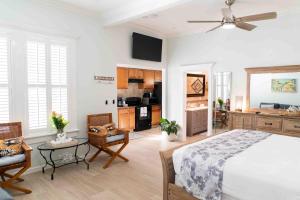 a large bedroom with a bed and a kitchen at Southernmost Point Guest House & Garden Bar in Key West