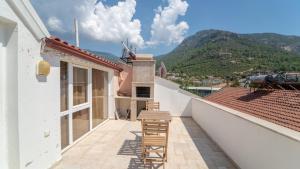 a balcony with two chairs and a view of a mountain at Villa w Terrace 5 min to Lycian Way in Fethiye in Fethiye