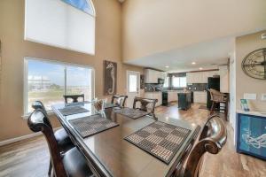 a dining room with a table and chairs and a kitchen at Beach Dream in Navarre