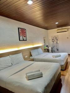 Katil atau katil-katil dalam bilik di Kangar Hotel Sdn Bhd