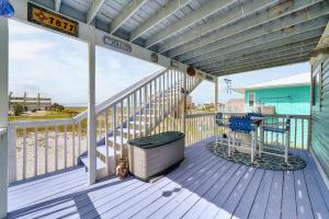a deck with a bench and a table on it at Beach Dream in Navarre