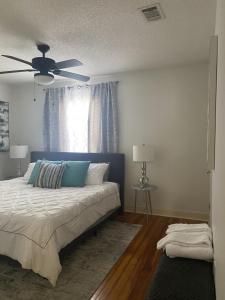 a bedroom with a bed and a ceiling fan at Luxury Home near South Historic District in Coffeyville