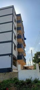 a tall building with balconies on the side of it at Akira Safaris Furnished Apartment in Migori