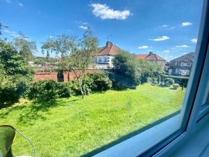 a view from a window of a yard with houses at Wonderful Apartment in London in The Hyde