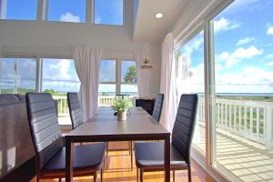 a dining room with a table and chairs on a balcony at Beach Bliss in Navarre