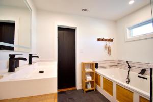 a bathroom with a tub and a sink at Beach Bliss in Navarre +31 photos