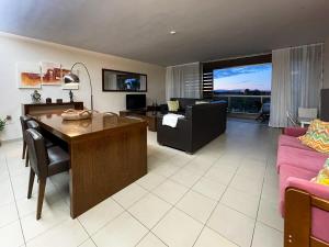 a living room with a table and a couch at Herdade dos Salgados, T3-11B2A, Vila das Lagoas, Albufeira in Galé