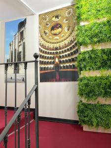 un muro con un dipinto di un edificio di Storico17 a Catania