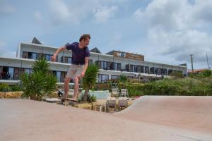a man riding a skateboard on a ramp at a skate park at WOT Ericeira Surf Hostel in Ericeira