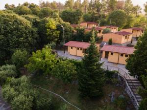 an overhead view of a row of houses in a forest at Village of Peace - House 26 in Shkodër