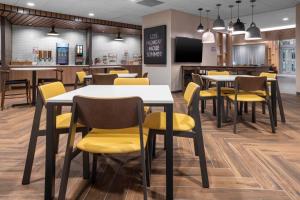 a dining room with tables and yellow chairs at Fairfield by Marriott Inn & Suites Dallas DFW Airport North, Irving in Irving