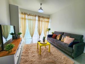 a living room with a couch and a tv at Dwiputra Presint 15 at Putrajaya Blissful Suite in Putrajaya