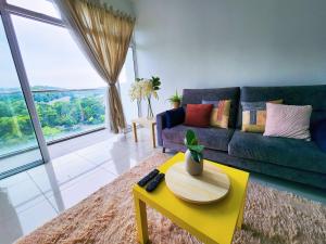 a living room with a couch and a yellow coffee table at Dwiputra Presint 15 at Putrajaya Blissful Suite in Putrajaya