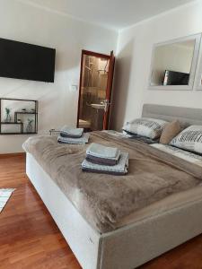 a large bed with towels on top of it in a room at Old city apartment in Rovinj
