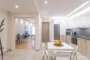 a kitchen and dining room with a white table and chairs at Amazing apartment near metro Station! in Athens
