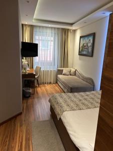 a hotel room with two beds and a desk at NV Luxury Suites & Spa in Belgrade