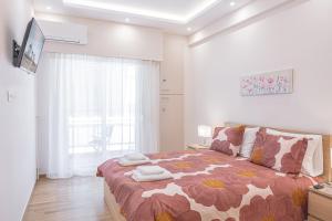 um quarto com uma cama grande e um cobertor de flores em Amazing apartment near metro Station! em Atenas