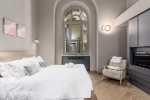 Ένα ή περισσότερα κρεβάτια σε δωμάτιο στο Q71 TIMELESS SUITES