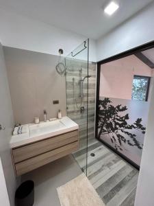 a bathroom with a sink and a shower at Atitlan Sunset Lodge in Santa Cruz La Laguna