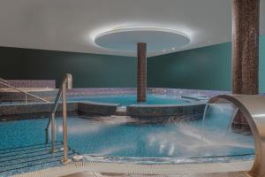 a large swimming pool with a water fountain at Hilton Dublin Kilmainham in Dublin