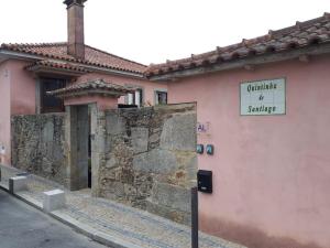 a building with a sign on the side of it at Quintinha de Santiago in Oliveira de Azemeis