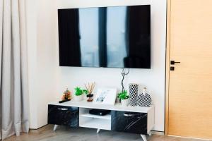 a black and white cabinet with a television on a wall at Luxury1BR at The Address Residences in JBR in Dubai