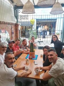 a group of people sitting around a table at Trip Monkey Zona G in Bogotá