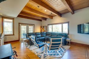 a living room with a blue couch and chairs at Meadow Vista Mountain Escape with River Views! 