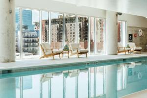 a swimming pool with chairs and a view of a building at Hilton Garden Inn Denver Union Station in Denver