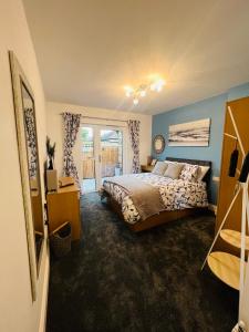 a bedroom with a bed and a large window at The Annex in Southend-on-Sea