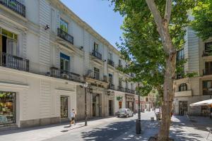 a person walking down a city street with buildings at Calm and bright apartment, center La Latina D.ALB in Madrid